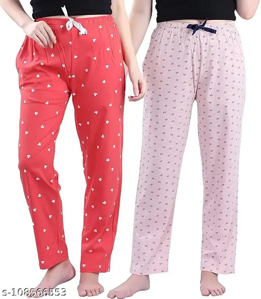 Female model wearing red and pink pajamas with polka dot print, two-piece loungewear