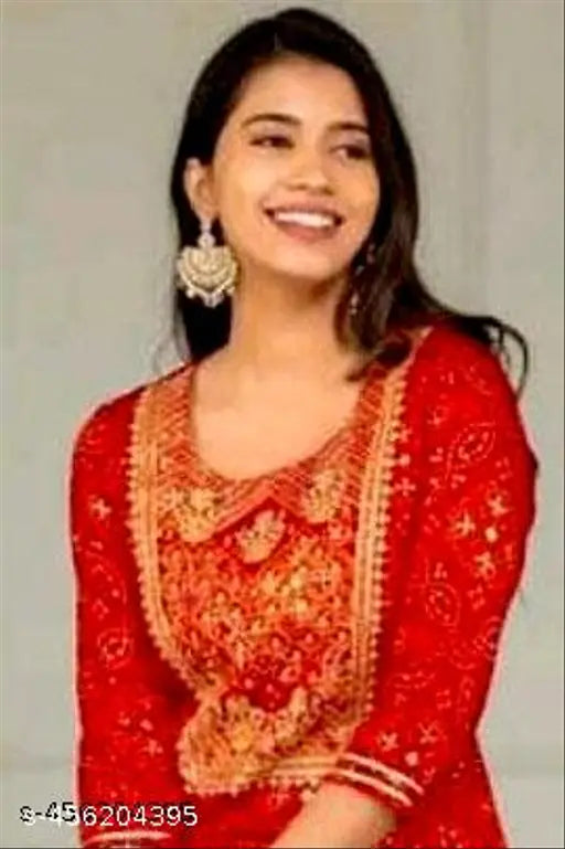 Red, embroidered traditional Indian suit, woman smiling