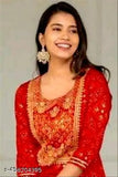 Red, embroidered traditional Indian suit, woman smiling