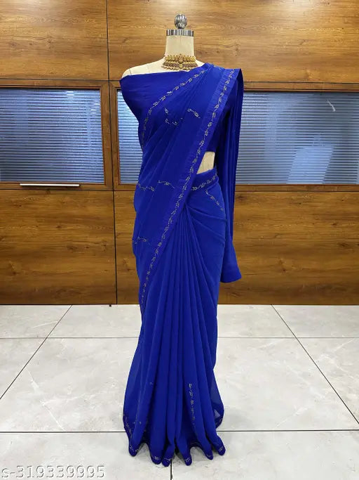 A georgette saree in a display case, light blue color with intricate embroidery design