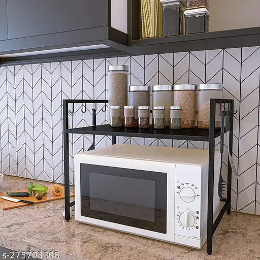 The microwave is placed on a black, metallic storage stand in a modern kitchen