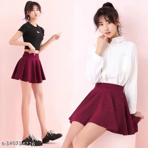 Polycotton flared mini skirt with attached inner shorts, solid color, high waistband and laser cutout scallop textured design. Size: 26-36 inches, imported from India