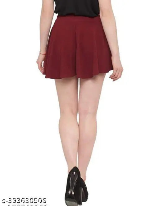 Polyester flared mini skirt, solid net, broad elastic waistband, curved hemline, breathable fabric. Multiple size options available for comfort and style. Indian-made flared skater skirt with regular rise for a versatile fit