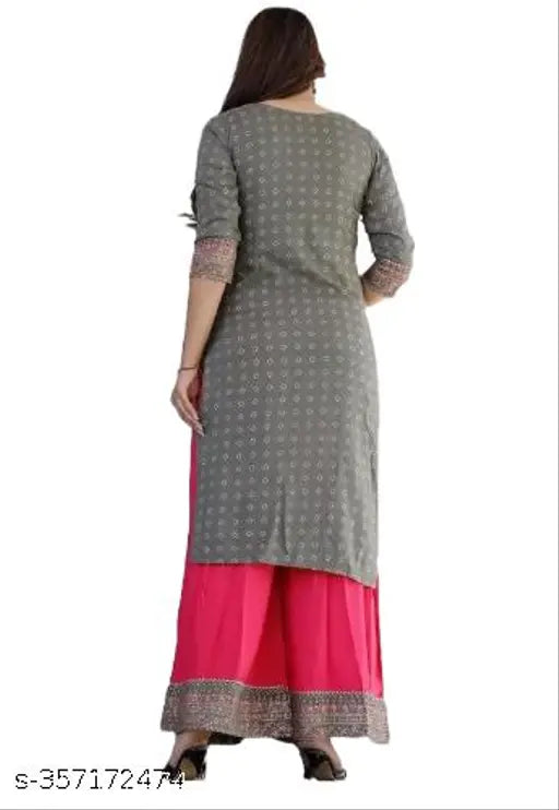 A woman wearing a block printed white kurta and pant set with a matching dupatta