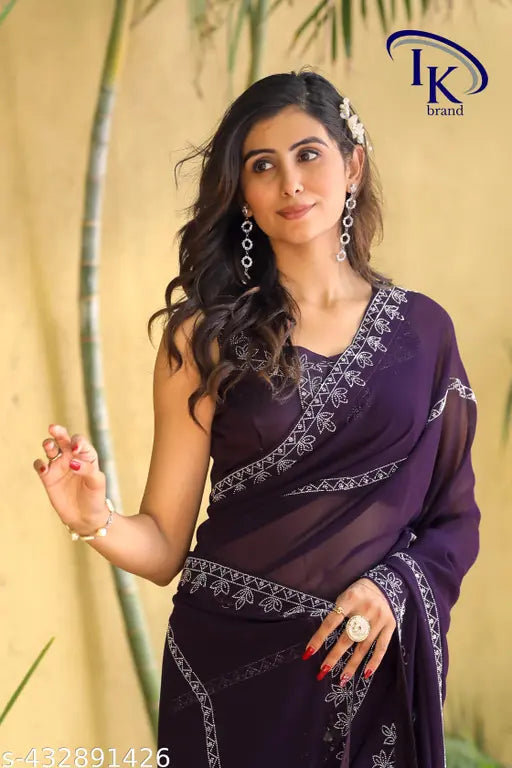 Fashionable purple chiffon saree with intricate design and pallu draped elegantly