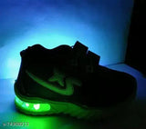 Black nike tennis shoe with glowing green soles