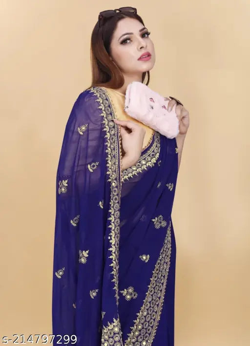 A blue georgette saree with an embroidered border, worn by a woman