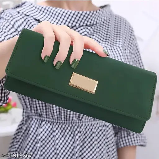 Black and white checkered dress, green purse with gold closure holding up the dress