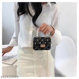 Black and gold sling bag with pearl accents, large main pocket, crossbody strap