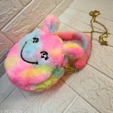 Colorful stuffed animal resembling a smiling face, attached to a mini sling bag for girls or kids