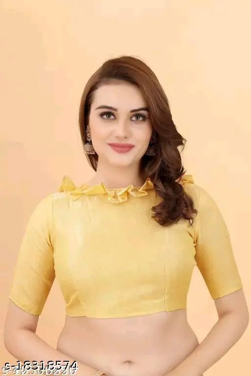 A yellow cotton saree with a mirror work pattern, styled in an elegant pose