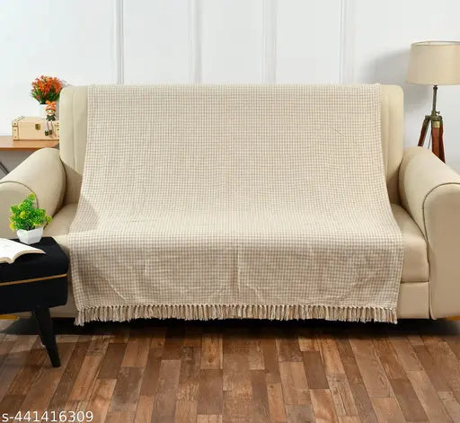 Beige plaid blanket with fringe for couch, soft texture, cozy addition