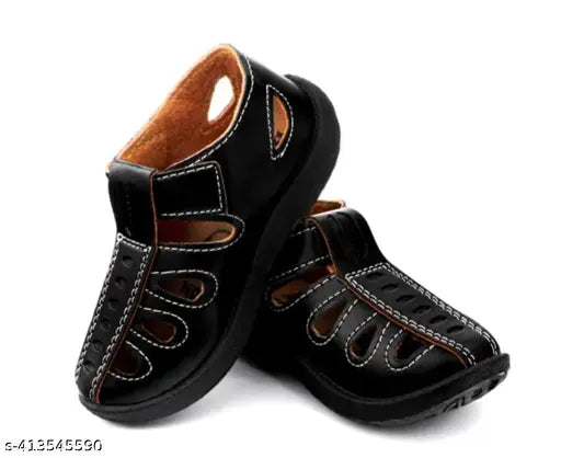Black, brown, and white sandals with velcro closure