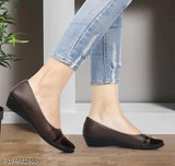 Woman wearing brown sandals, blue jeans