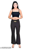 A woman wearing high-waisted, baggy-legged pants in a solid color
