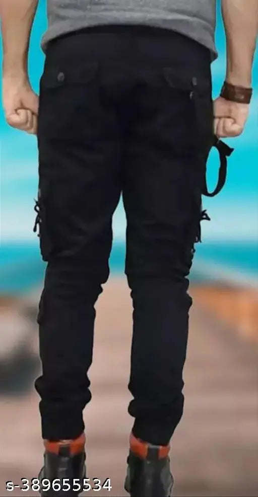 Black cotton blend cargo jeans for men by Flaying Men DFIE, size 28/30/32/34 with 41in length and respective hip sizes. Solid black workwear jeans on model