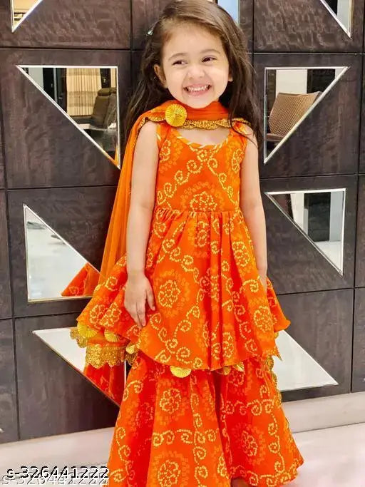 Orange rayon anarkali kurta and sharara set for kids with printed design, embellishments, and traditional patterns. Sizes range from 3-4 years to 11-12 years, each with specific length sizes provided. Indian ethnic wear originates in India