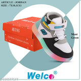 Children's black and blue sneakers with laces, inside a red and white box