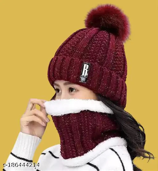Maroon knitted beanie with fur ball on top