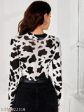 Printed black and white animal lycra long-sleeve T-shirt with crop fit, featuring cow print and sheer sleeves on display
