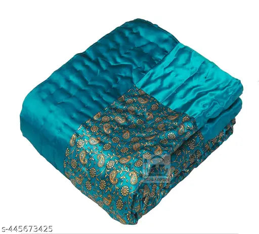 Teal satin single bed quilt with gold paisley pattern
