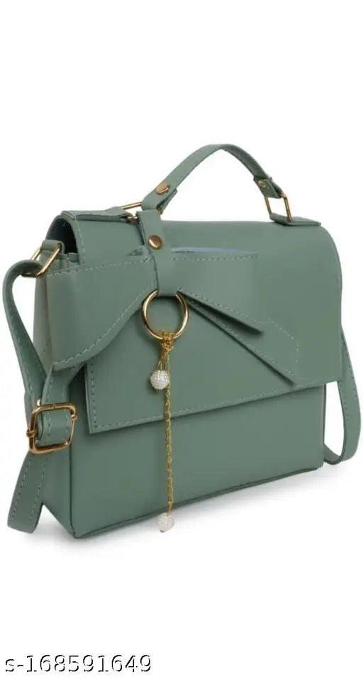 A synthetic vegan leather crossbody handbag with a top handle and shoulder strap, featuring a unique design with metallic details