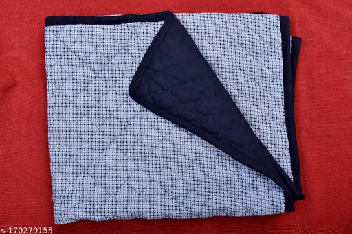 Black and white quilt with a geometric design, neatly folded
