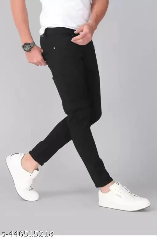 A man in a white t-shirt and black jeans, striding confidently
