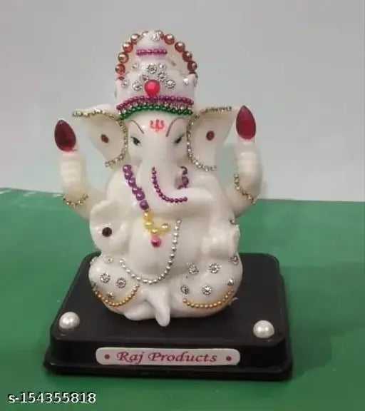 Decorative idol with jewelry, adorned in red and gold ornaments