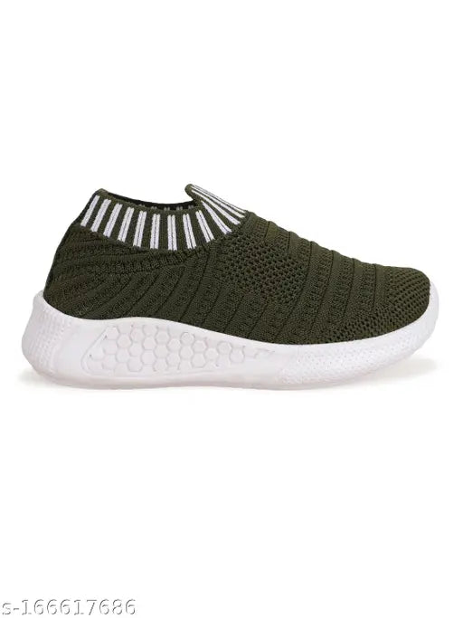A child's pair of light olive green sneakers with white laces and a striped sock design