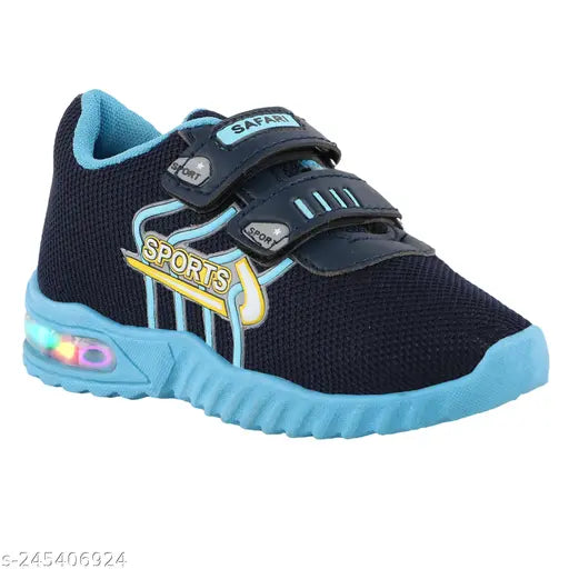 This is a black and blue shoe with a Velcro strap, an LED light on the upper, and a sports-inspired design. It appears to be designed for kids' use in sports activities