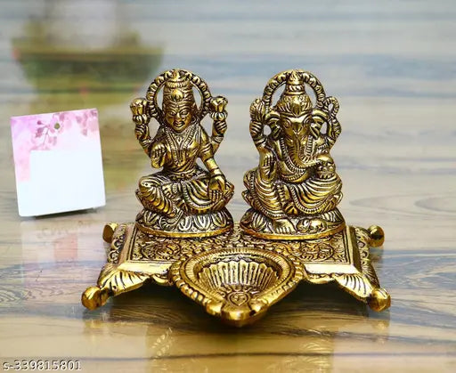 Brass handcrafted Lakshmi-Ganesha idols with diya - exquisite Indian temple decor, perfect for puja rooms, home offices or Diwali gifts. Dimensions: 15cm (L) x 10cm (H) x 12cm (B)