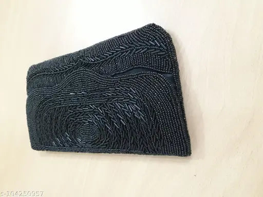 Black beaded women's clutch with a chain strap, featuring intricate patterns and designs