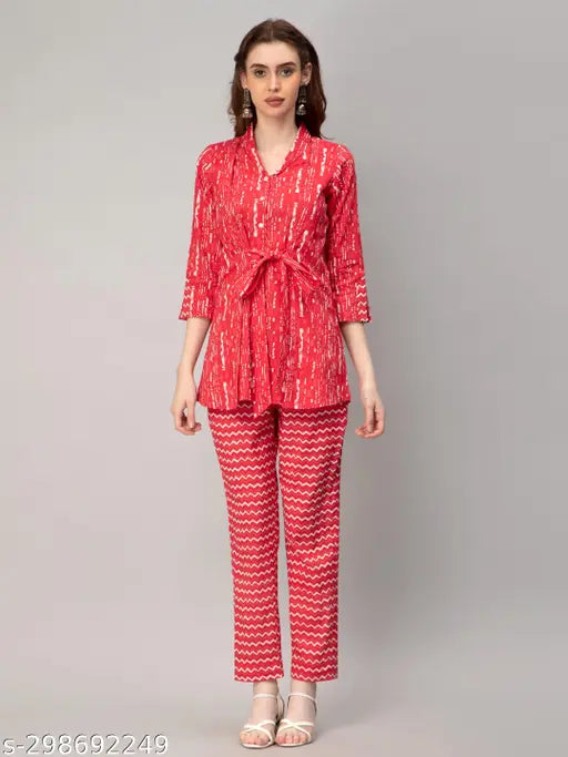 Red cotton coords set: Printed top & trousers with v-collar, three-quarter sleeves, button closure, and belt. 100% cotton for comfort. Indian origin