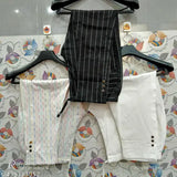 White children's pants with button closure, hung together on hanger