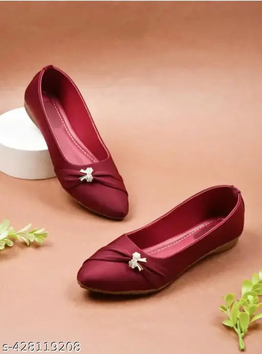A burgundy bellie flat with bow detailing