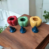 Three colorful Madark bell pepper ceramic jars, each with a lid and a decorative knob on top