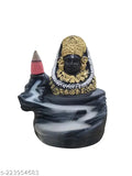 The image shows a black and yellow Khushi Enterprises idol with an intricate design, featuring multiple arms adorned in gold jewelry. It is displayed on a dark surface against a contrasting background