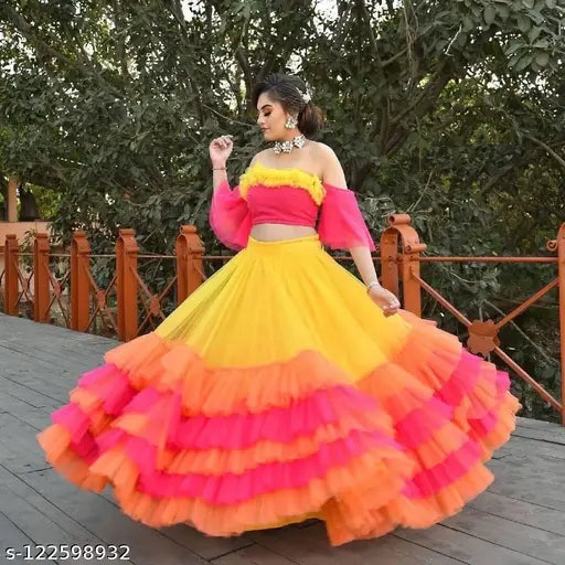 Designer net material multi-colored semi-stitched lehenga choli with ruffled blouse, featuring yellow, orange, and pink hues. Indian traditional attire showcasing net fabric and lace detailing