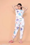 White cotton blend floral round nightsuits for women, featuring a shirt top and pyjama bottoms with short sleeves and printed net pattern. Perfect for casual brunch, professional meetings, or nights out. Mix-and-matchable with other wardrobe staples. Made in India (N: 1, XS-XL sizes available)
