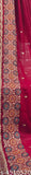 Embroidered paisley pattern on red fabric, likely silk or chiffon, with intricate floral designs and geometric patterns