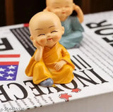 Small figurines of Buddha monks sitting in a row