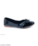 A flat pair of black shoes with a bow at the back, showing a side profile