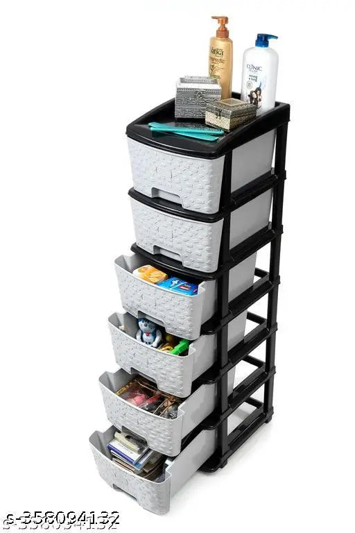 Gray plastic drawer organizer system with multiple compartments and a designated space for toys, books, clothes, and shoes