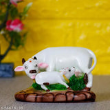 Marble-look poly resin Krishna idol, Kamdhenu Cow & Calf statue for pooja mandir interior decoration. Made with fine grade marble powder, durable colors, and easy to clean with cotton cloth. Size: L13cm x W8cm x H9cm, weight: 215gm. Origin: India