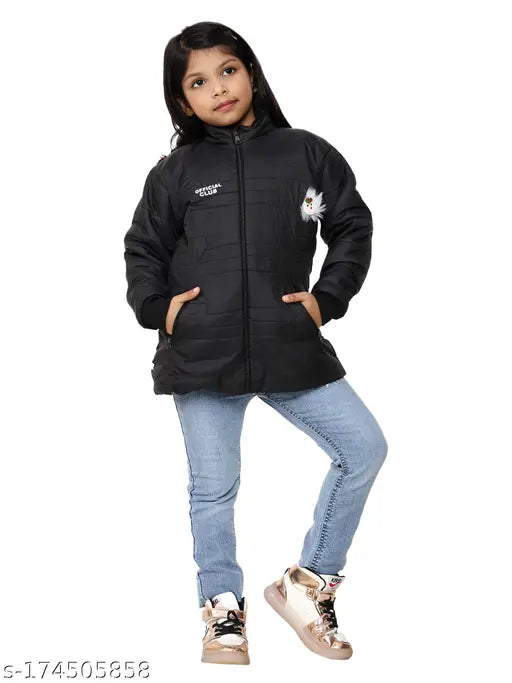 Little girl wearing a black and white jacket with a hood, blue jeans