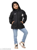Little girl wearing a black and white jacket with a hood, blue jeans