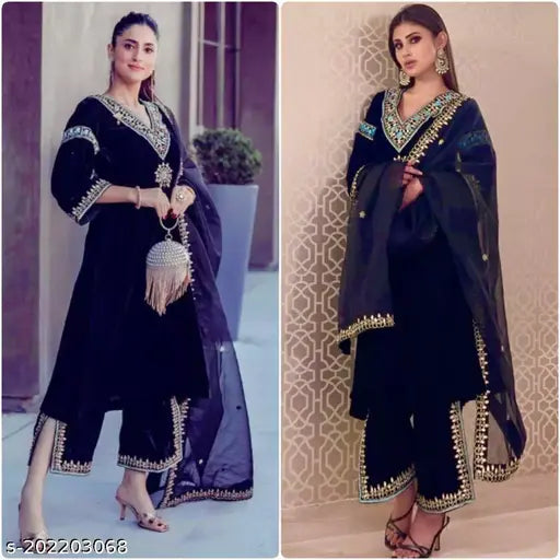Black velvet embroidered outfit with sequined embellishments and bell sleeves