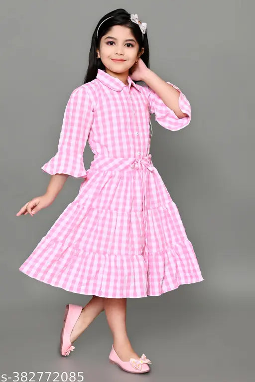 Pink gingham dress with puff sleeves and pleated skirt