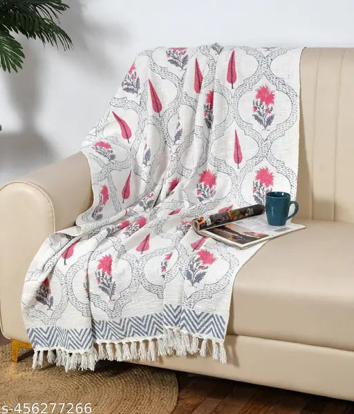 Multi-colored throw blanket with intricate block print design, suitable for sofa or bed